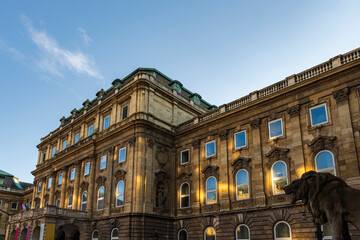 Historic Stone Building with Lion Statue and Arched Windows © iBennn