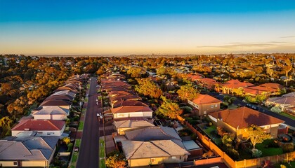 Naklejka premium aerial view of suburban terrace houses in golden afternoon light in west melbourne in victoria
