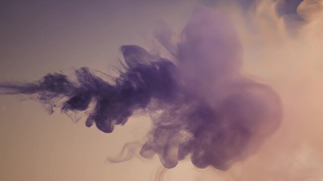 Abstrack motion of dark liquid splashing in water, creating abstract shapes and patterns from a close-up viewpoint