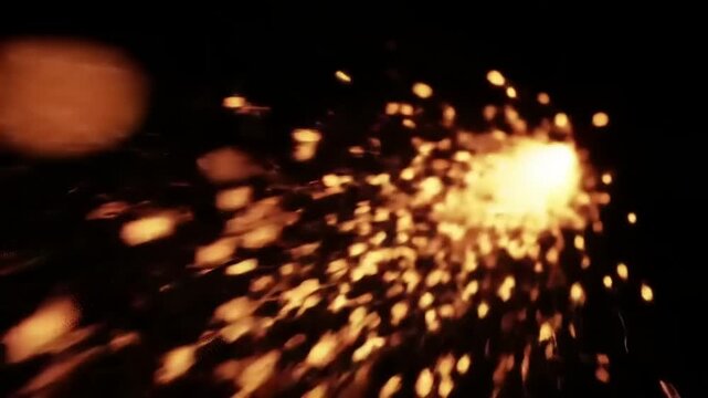 Sparks flying on black background.