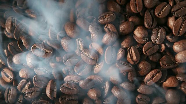 Close-up shot of freshly roasted coffee beans with aromatic steam rising, creating a warm and inviting atmosphere for coffee lovers