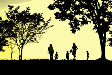 Fototapeta premium A family silhouetted against a vibrant golden sunset landscape