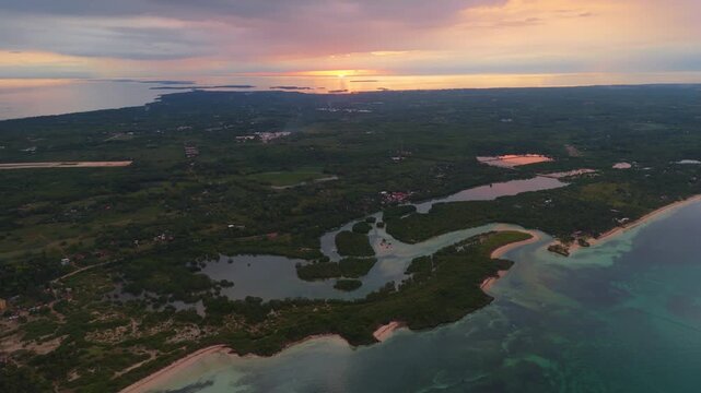 Stunning aerial drone panorama of a golden sunset over the mangrove forests and sandbars of Bantayan Island