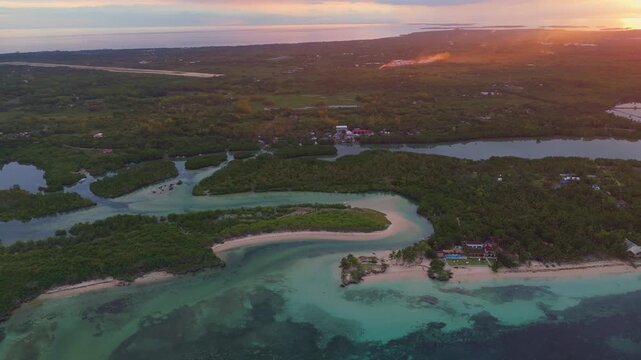 Cinematic sunset panorama of a tropical island in the Philippines, featuring vibrant skies and mangrove forests