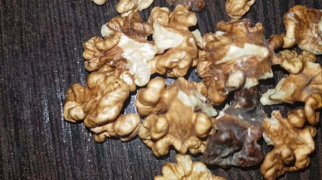A close-up shot of the walnut kernel reveals the flavorful, nutrient-rich meat extracted from its shell, showcasing its distinctive texture.
