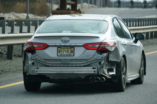 New Jersey, U.S.A - Feb 21, 2026 - The rear-end damage visible on a Toyota Camry SE traveling on a roadway, exposing internal bumper components.