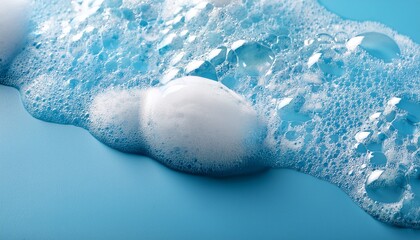 close up of soapy foam on a light blue surface