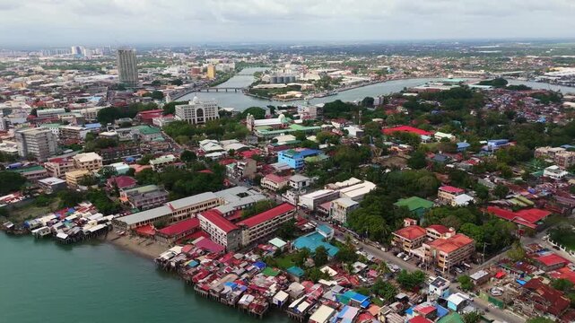aerial vista of Iloilo City&rsquo;s downtown area, capturing the lush central park and the iconic river esplanade under bright daylight