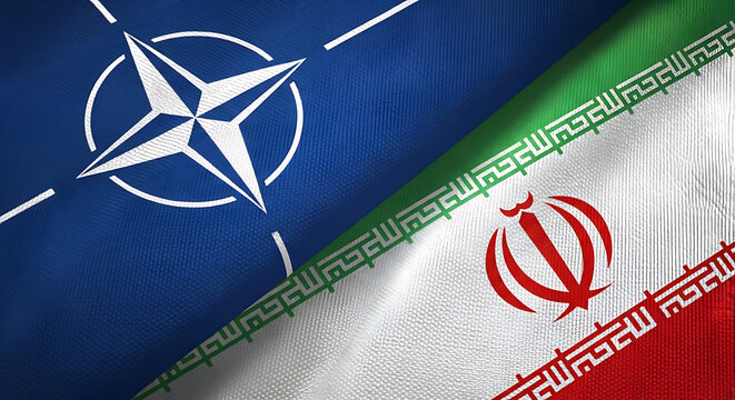 The iconic NATO flag and the national flag of Iran diagonally juxtaposed, signifying complex international dynamics.