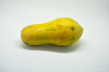Whole Ripe Yellow Papaya Fruit Isolated on White Background, Studio Shot of Fresh Tropical Pawpaw, Concept of Healthy Exotic Food, Antioxidant Nutrition, Summer Fruits, and Vegan Lifestyle
