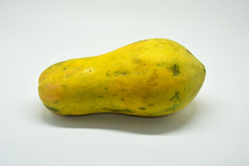 Whole Ripe Yellow Papaya Fruit Isolated on White Background, Studio Shot of Fresh Tropical Pawpaw, Concept of Healthy Exotic Food, Antioxidant Nutrition, Summer Fruits, and Vegan Lifestyle