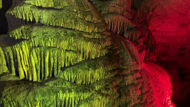 illuminated stalactites, travertines, and textures of the cave's interior detail
