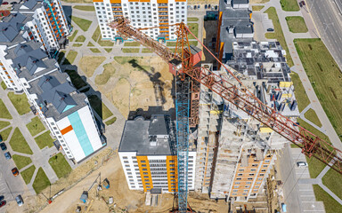 modern apartment building under construction. development of new residential area. aerial view of city construction site.