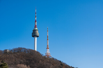 Fototapeta premium N Seoul Tower with autumn landscape. It is also known as Namsan Tower or Seoul Tower, the landmark which is a communication and observation tower located on Nam Mountain in central Seoul, South Korea