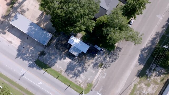 Neighborhood homes in Grove Hill, Alabama with drone video moving overhead.
