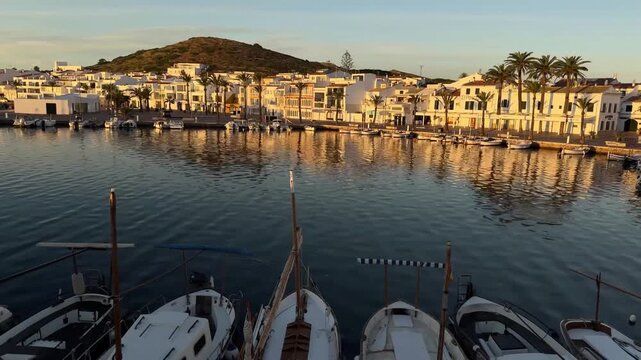 Golden Hour Over Fornells Harbor: Traditional Boats and White Architecture in Menorca
