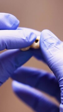 Close up of dental dentures with artificial teeth presented by dentist in clinical environment Emphasizing prosthetic care for patients with tooth loss and need for aesthetic and rehabilitation