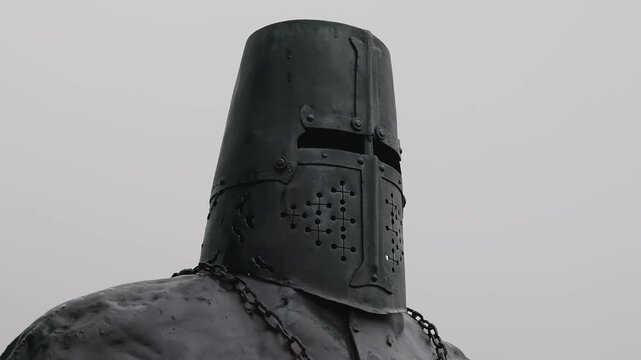 A knight in a dark room or dungeon. This could be a moment of mystery or danger.