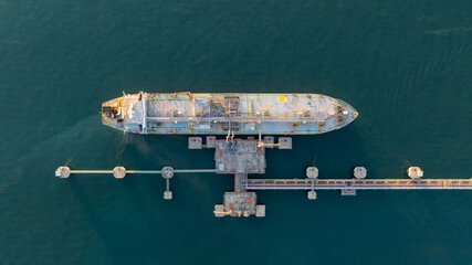 Aerial view oil and gas ship tanker vessel loading unloading in oil terminal station refinery, Global business import export logistic transport sea freight cargo tanker, Oil gas tanker ship at port. © Kalyakan
