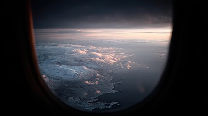Aerial View of Cityscape and Sea From Airplane Window During Golden Hour Sunset with Dramatic Cloudscape