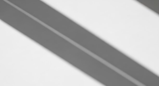 Close-up view of a sleek, modern, silver-colored metal surface with two parallel lines