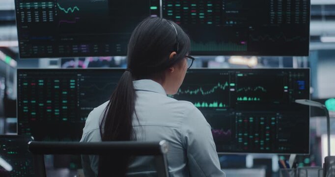 Professional Asian Woman Dressed in Business Attire Works Cutting Edge Station in Massive Exchange Center. Concept of High Productivity Environments and Evolution of Innovative Digital Office.