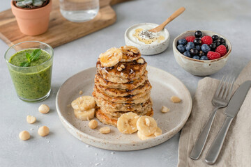 Healthy breakfast banana oatmeal pancakes with berries and honey