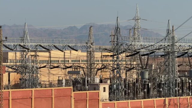 Electrical substation with transformers and high voltage structures in desert city