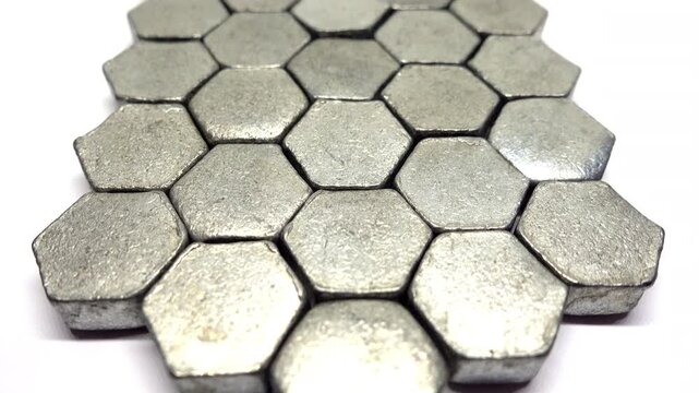Slow moving view above a pattern of metal hexagons.