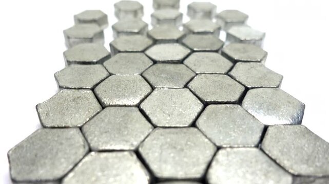 Backward moving view of metal hexagons that become more tightly packed together.