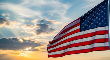 American flag waving in the sunset with a cloudy sky