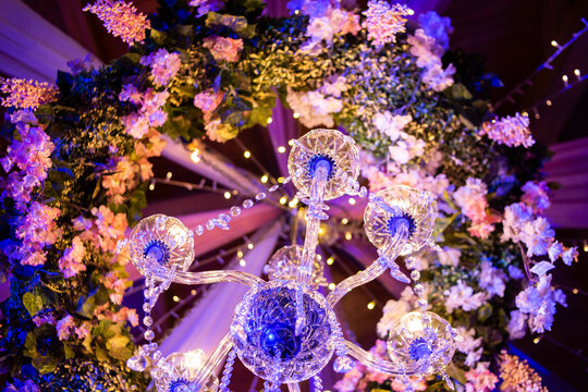 Luxury floral decoration with chandelier lighting for an elegant wedding or special event.