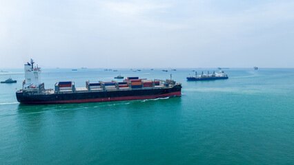 Massive commercial container ship loaded with colorful freight sailing across the deep blue ocean. Global maritime logistics, international trade, and commercial shipping industry business concept.