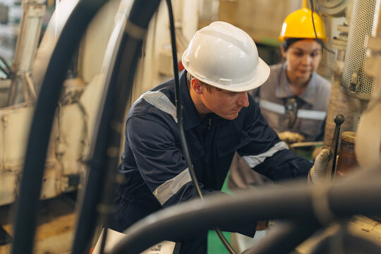 Engineer worker man working. Technician Engine Mechanic work maintenance machine in industry factory