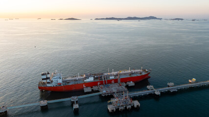 Aerial view oil and gas ship tanker vessel loading unloading in oil terminal station refinery, Global business import export logistic transport sea freight cargo tanker, Oil gas tanker ship at port. © Kalyakan