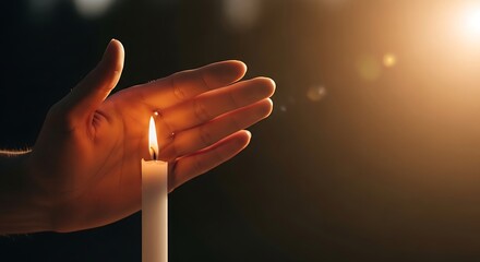 Hand shielding a candle flame, warm light, spiritual moment, hope, faith, and peace.