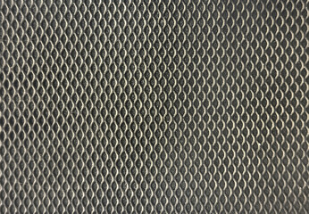 Close up of black perforated wiremesh metal with black background. Red perforated panel texture. Seamless graphic background texture. © TMR Studio