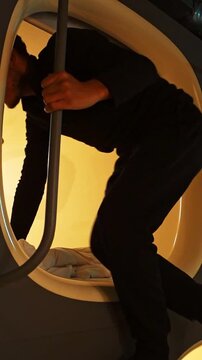 Traveler Staying in Compact Capsule Hotel Accommodation