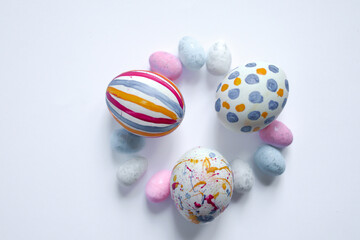 Easter holiday postcards.  Postcards for greetings, leaflets. Easter celebration 2026. White, pink, blue, yellow, green colors of Easter decorations. Ester eggs, chocolate rabbits on white, pink and d