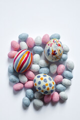 Easter holiday postcards.  Postcards for greetings, leaflets. Easter celebration 2026. White, pink, blue, yellow, green colors of Easter decorations. Ester eggs, chocolate rabbits on white, pink and d