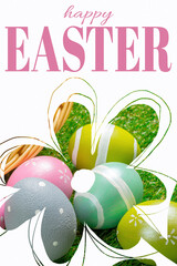 Fototapeta premium Colorful Easter eggs in a basket on grass with happy Easter text above