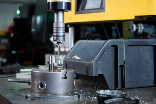 A close-up of equipment for threading metal bushings.