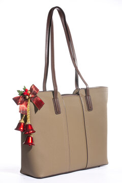 Beige women's leather bag on a white background