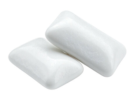 Two soft, white, rectangular-shaped chewing gum pieces