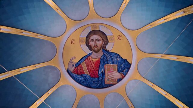 A detailed view of the monumental golden mosaic depicting Jesus Christ within the central dome of the modern Orthodox Cathedral featuring traditional Eastern iconographic art and symmetry