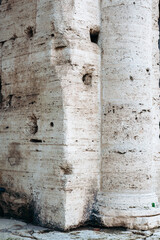 Naklejka premium Ruins of ancient stone wall by a column in a historic location in daylight