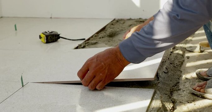 A detailed look at tile installation process showcasing expert craftsmanship in a home improvement project.