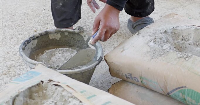 Workers mix concrete at a construction site showcasing essential process in building structures.