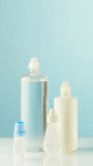 Minimal Cosmetic Bottle Set In Soft Blue Tones On Clean Background. Concept of Skincare Packaging Mockup, Beauty Brand Identity Presentation, Personal Care Product Line Display, And Cosmetic Visual