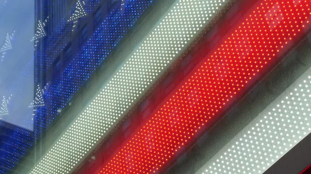 American flag on Broadway, Times Square in New York City, United States. Electric lights glowing. Symbol of democracy, national attribute of USA. 4th July or 911 September 11 concept. Military Island.